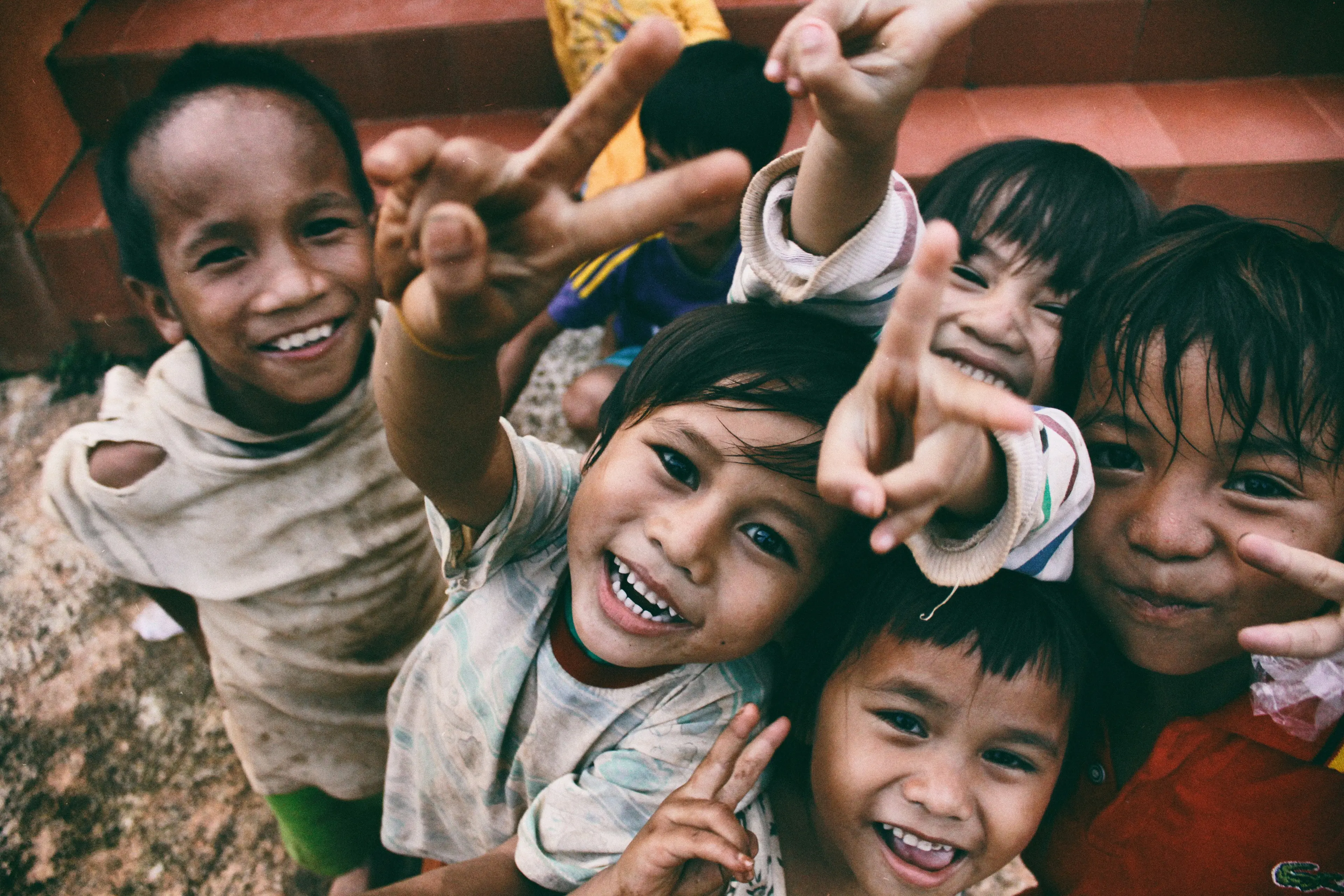 Children reaching out towards the camera